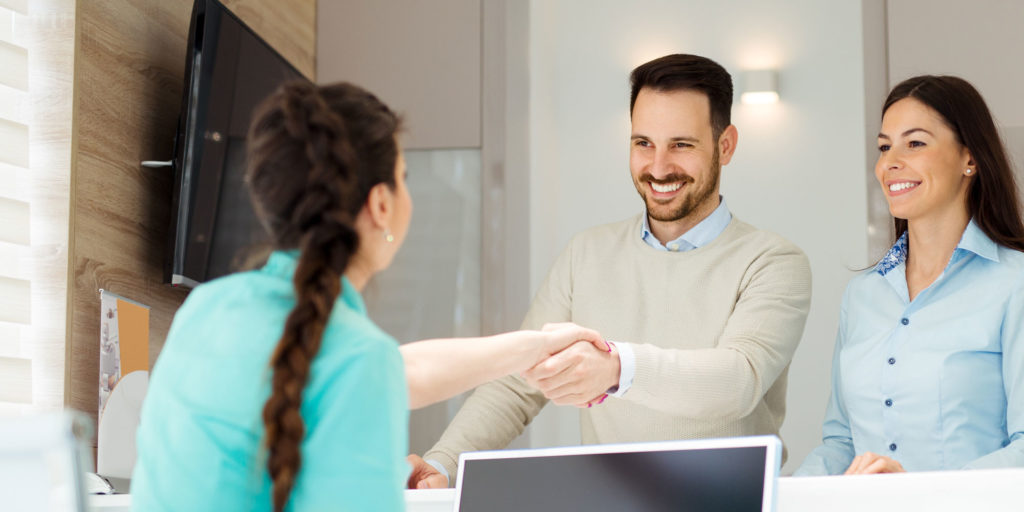 office manager welcoming dental patients