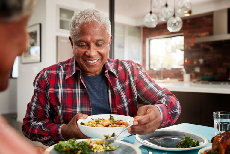 Dental Implant Patient Eating And Smiling