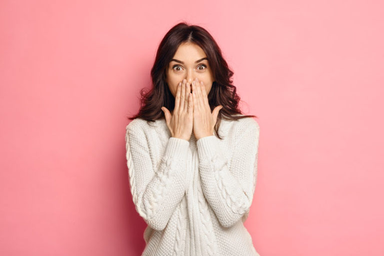 Dental Patient Shyly Covering Her Missing Tooth