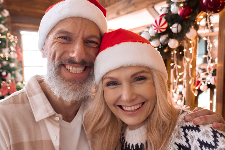 Dental Implant Patients Smiling During A Holiday Event