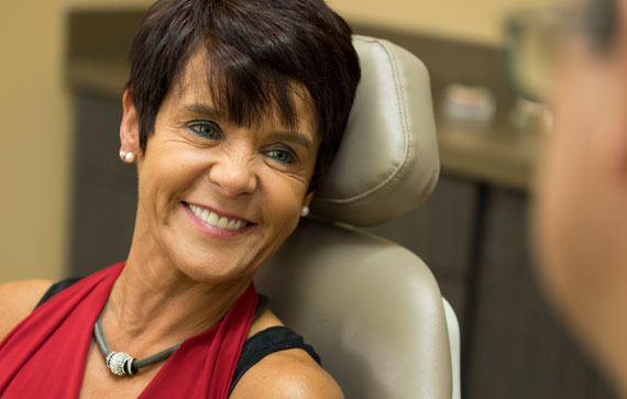 a dental patient smiling with full mouth dental implants.