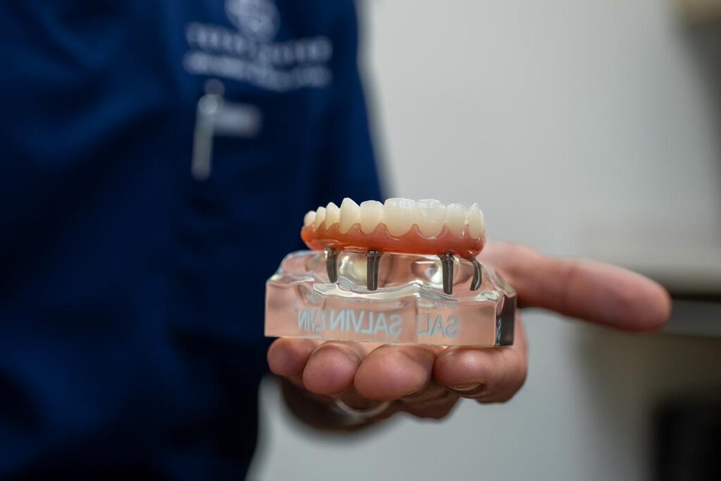 Oral Surgeon Holding All In One Smile Prosthetic