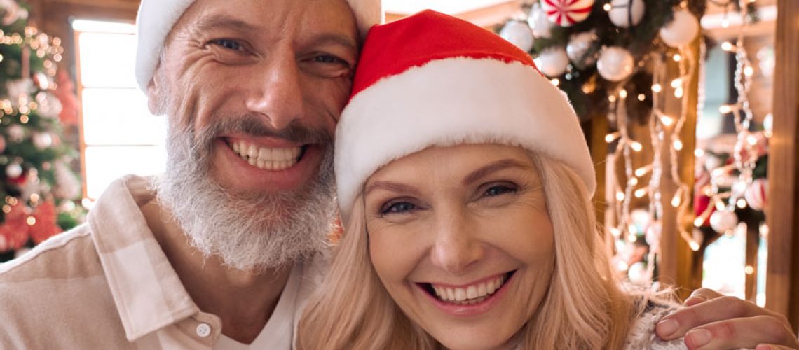 Dental Implant Patients Smiling During A Holiday Event