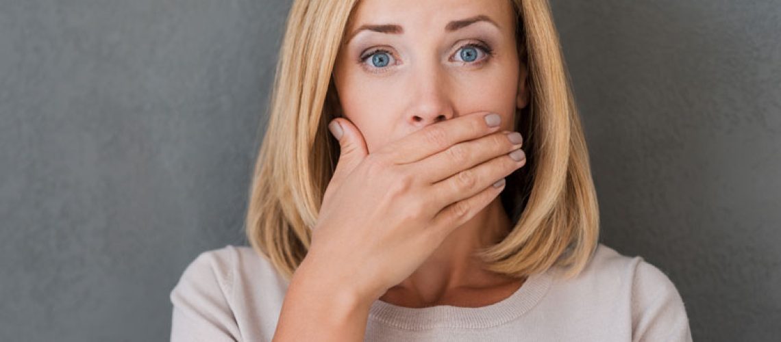 Dental Patient Covering Her Mouth.