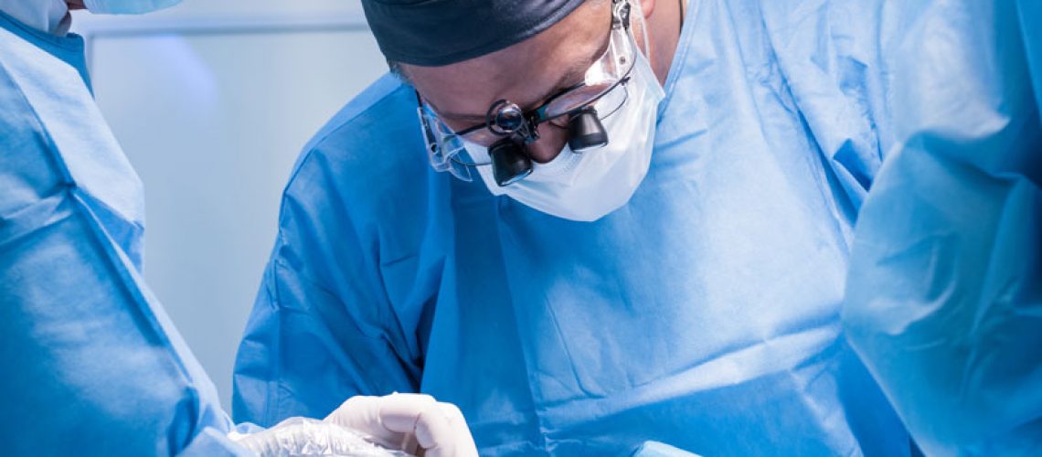 an oral surgeon performing dental jaw surgery